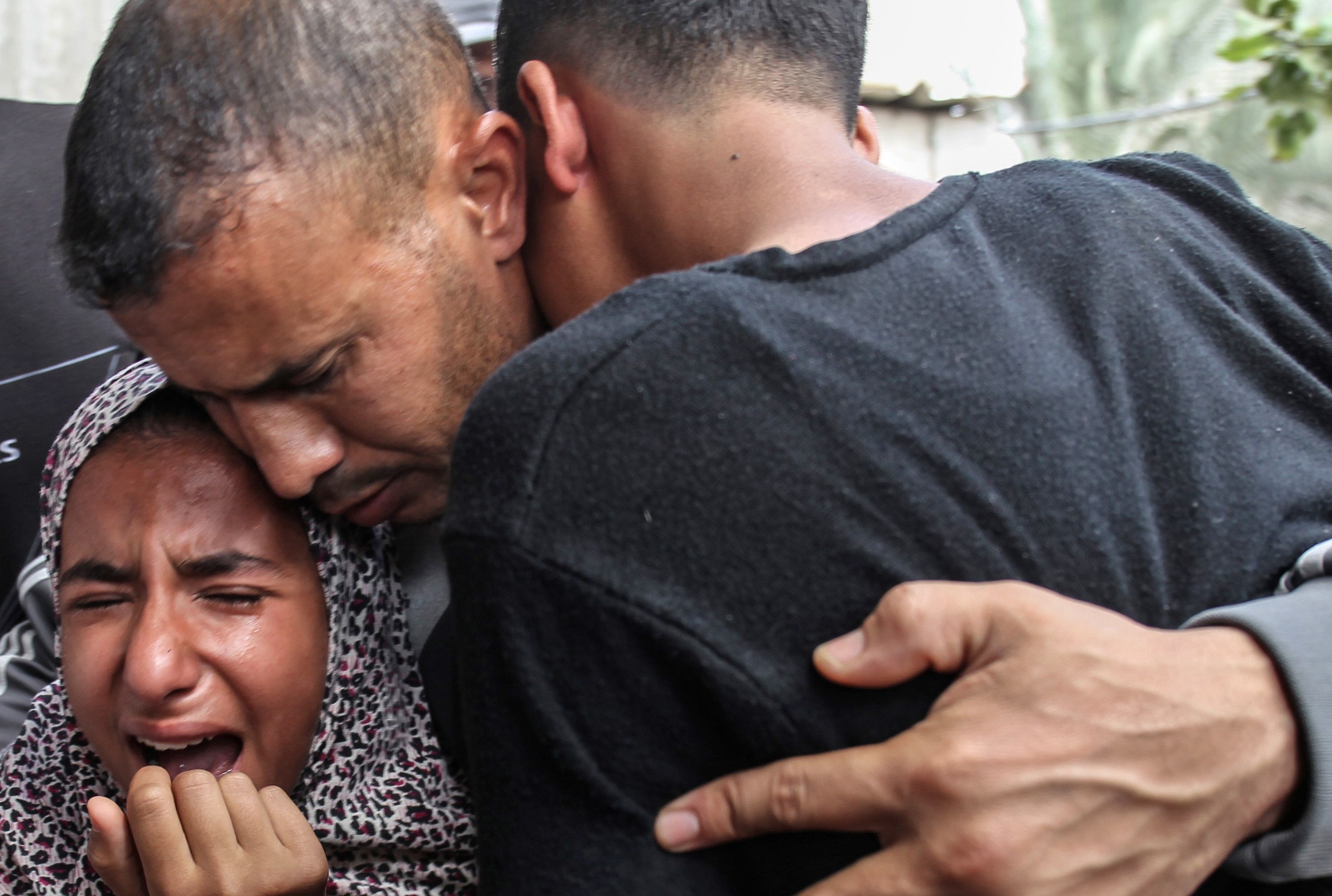 Rouba (L) and Wassim (R) mourn their father, 40-year-old Palestinian Jaber Abu Mustafa, who succumbed to his wounds after being shot by the Israeli army on 12 May 2018 (AFP)