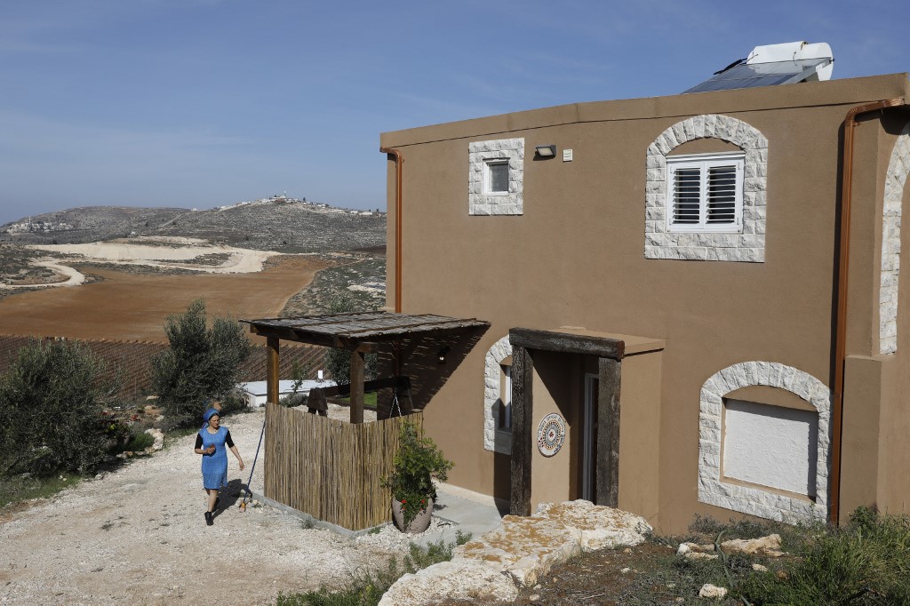 An Airbnb apartment owner walks outside of her apartment in Adei Ad outpost north of the Palestinian village of al-Mughayyir, near the occupied West Bank city of Ramallah on 20 November 2018. (AFP)