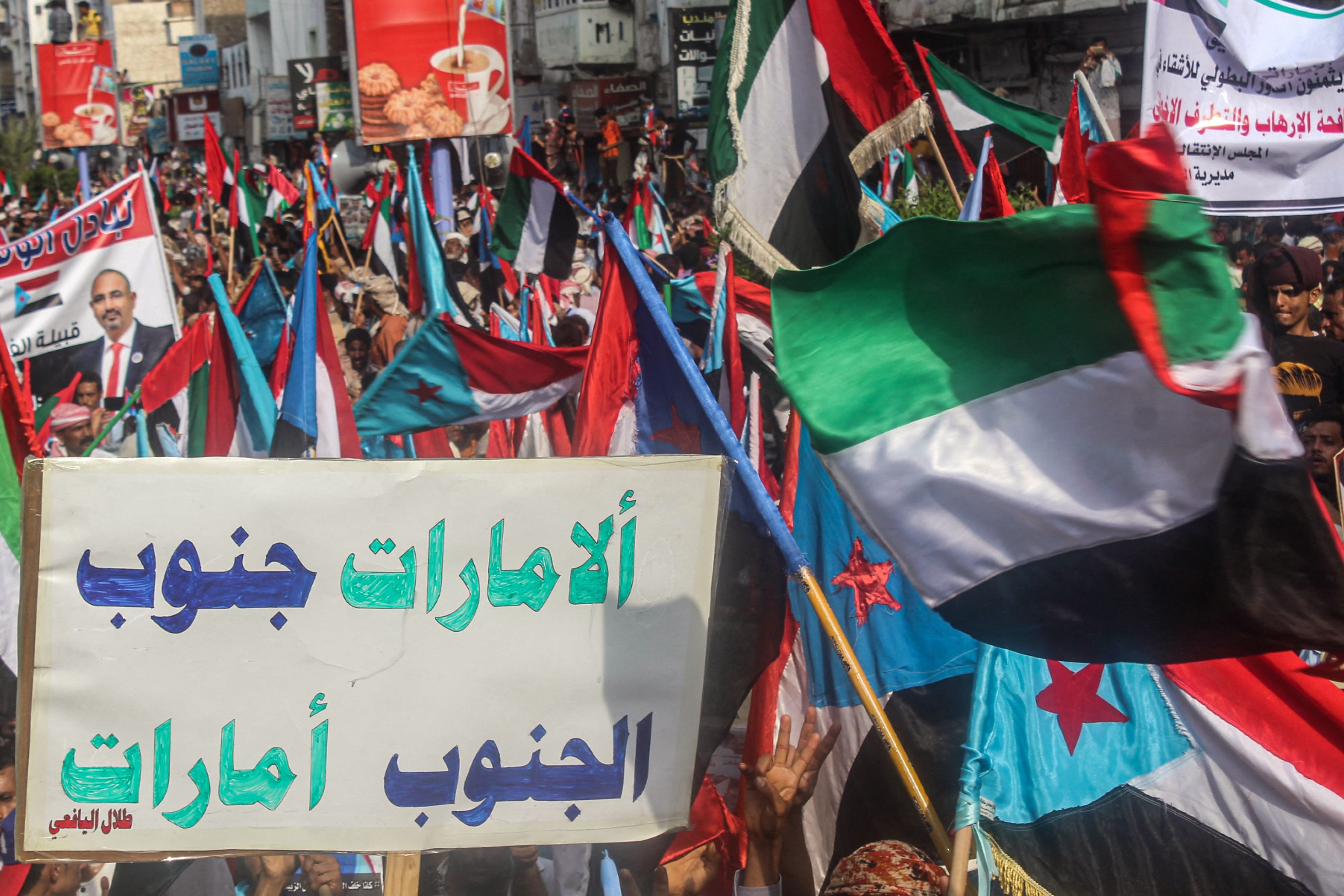 People march with a sign reading in Arabic 