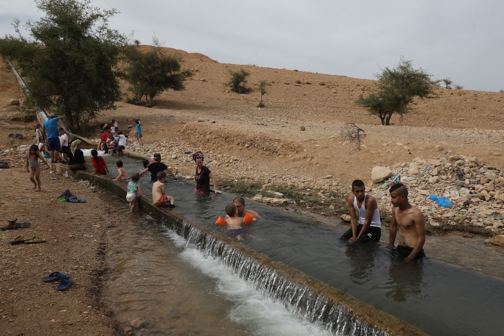 Palestinian youths and Jewish settlers in the West Bank