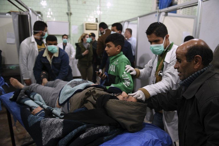 A Syrian man is brought for treatment at a hospital in Aleppo on 24 November (AFP)