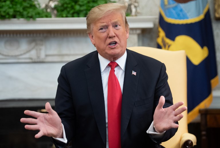 US President Donald Trump speaks in Washington on 27 March (AFP)