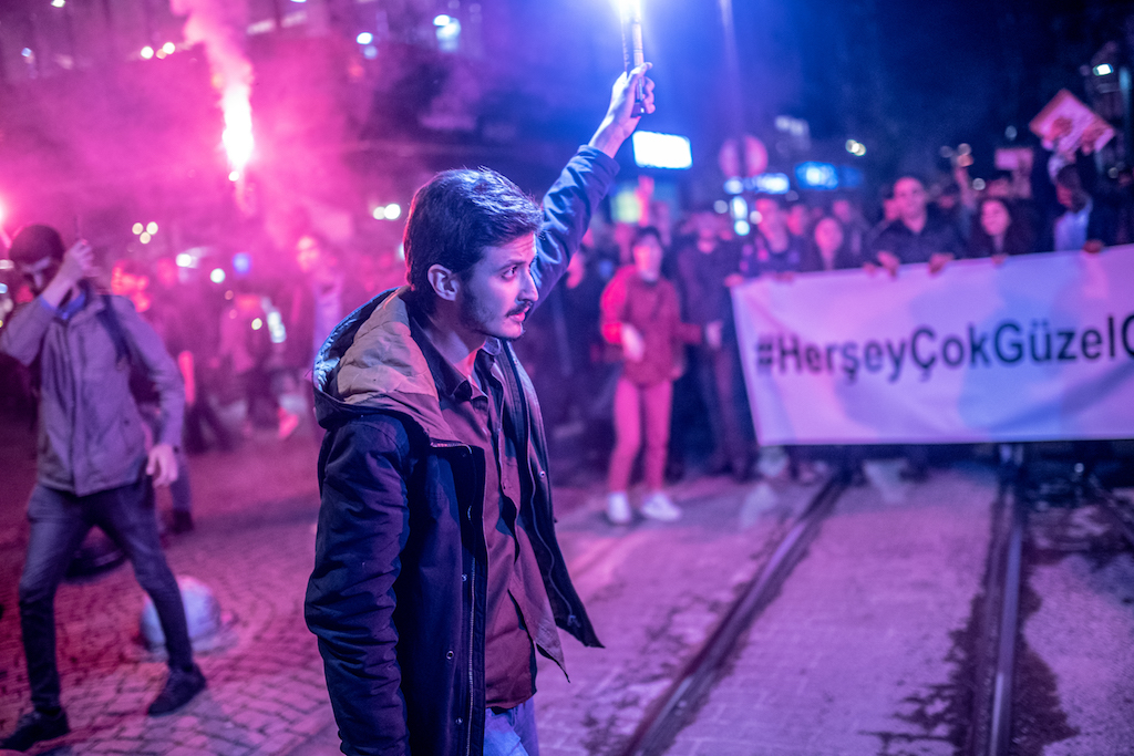 Protesters hold torchs during a demonstration in Istanbul on 8 May following the YSK's decision (AFP)