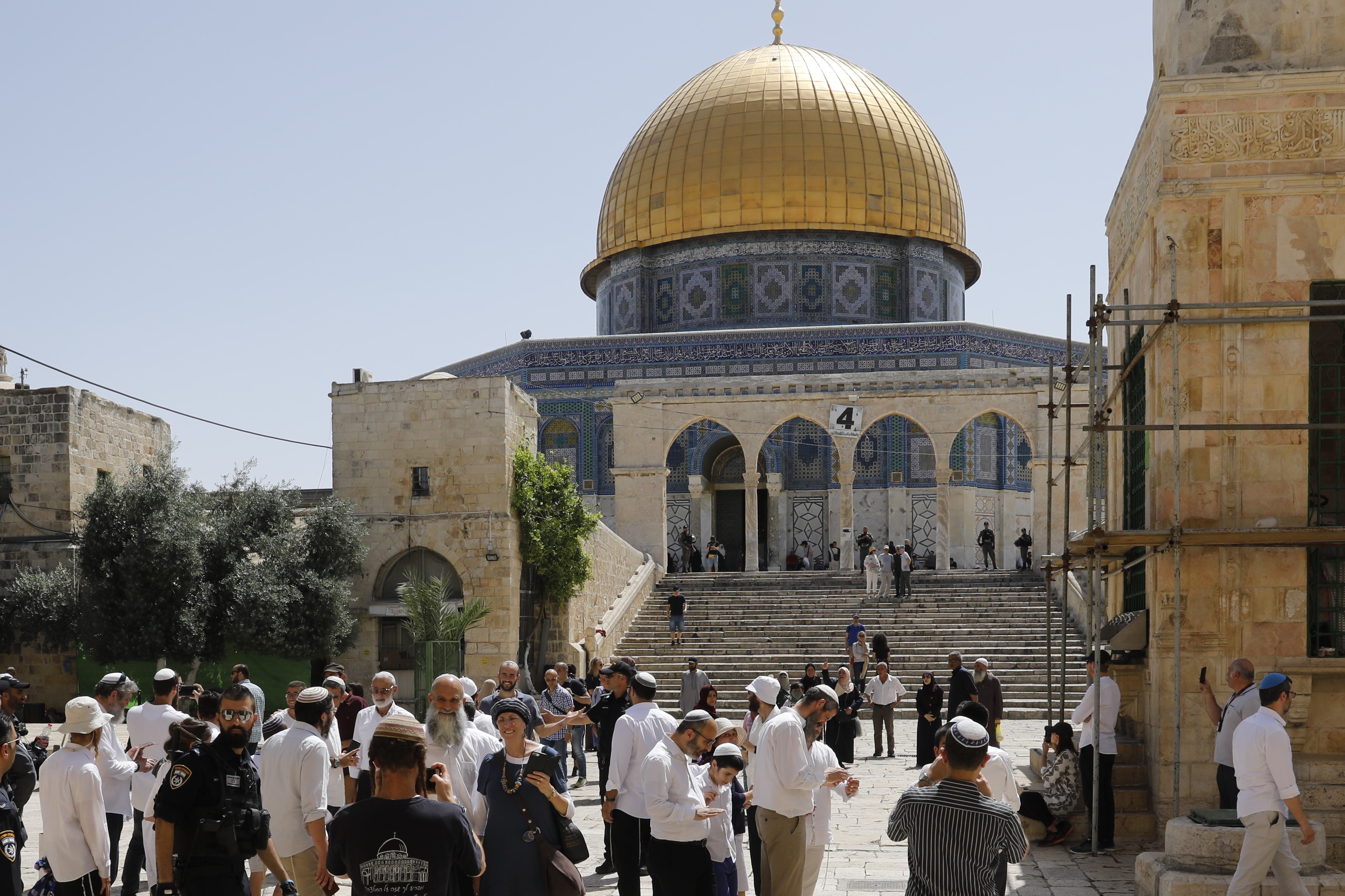  Israeli security forces escort a group of Jewish settlers visiting the Al-Aqsa Mosque compound on 2 June (AFP)