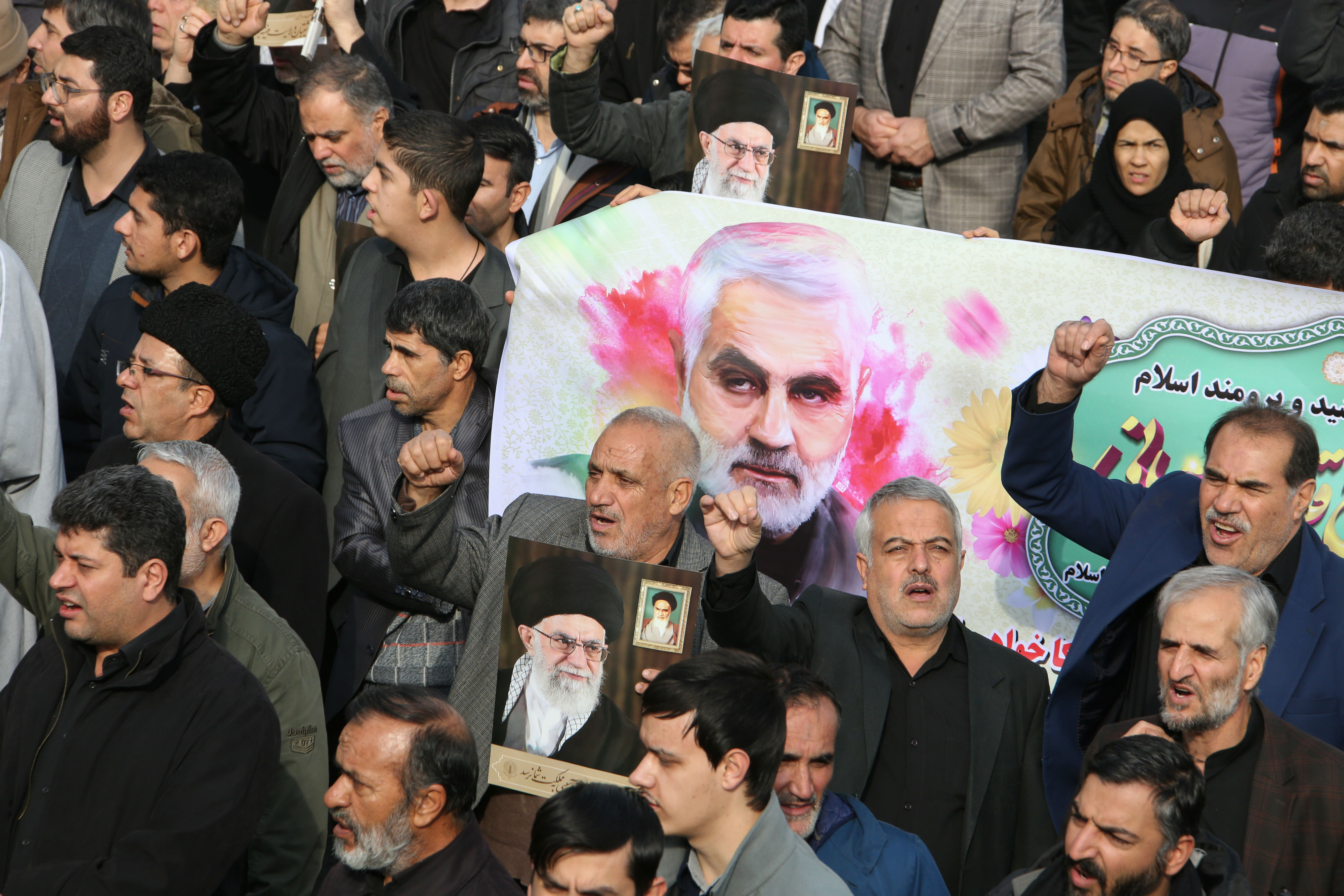 Iranians march with a banner bearing an illustration of Iranian Revolutionary Guards Major General Qassem Soleimani during a demonstration in Tehran (AFP)