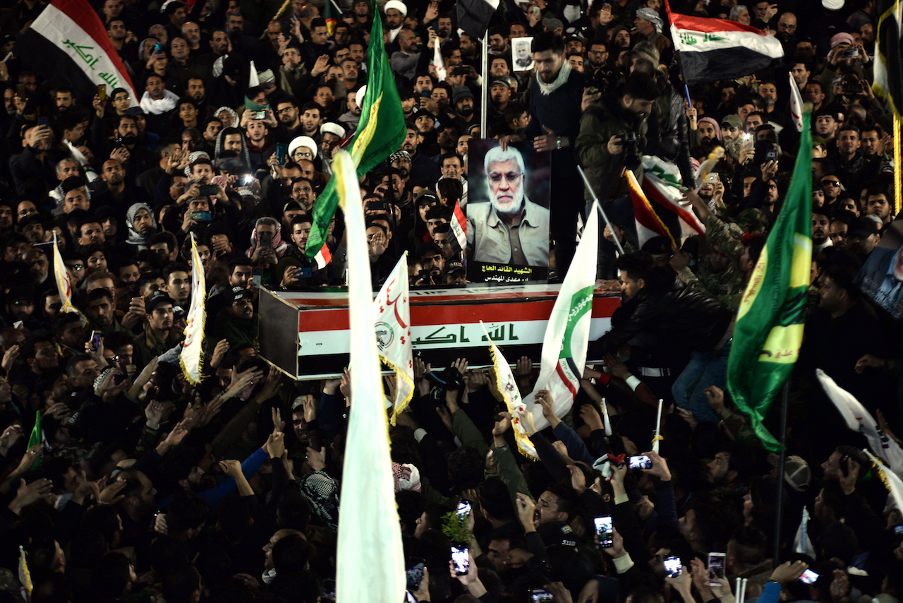 Mourners carry the coffin of slain Iraqi paramilitary chief Abu Mahdi al-Muhandis, toward the Imam Ali Shrine, in the shrine city of Najaf in central Iraq during a funeral procession (AFP)