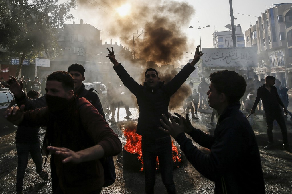 Palestinians youth protest inside the Gaza Strip against Trump's deal (AFP)