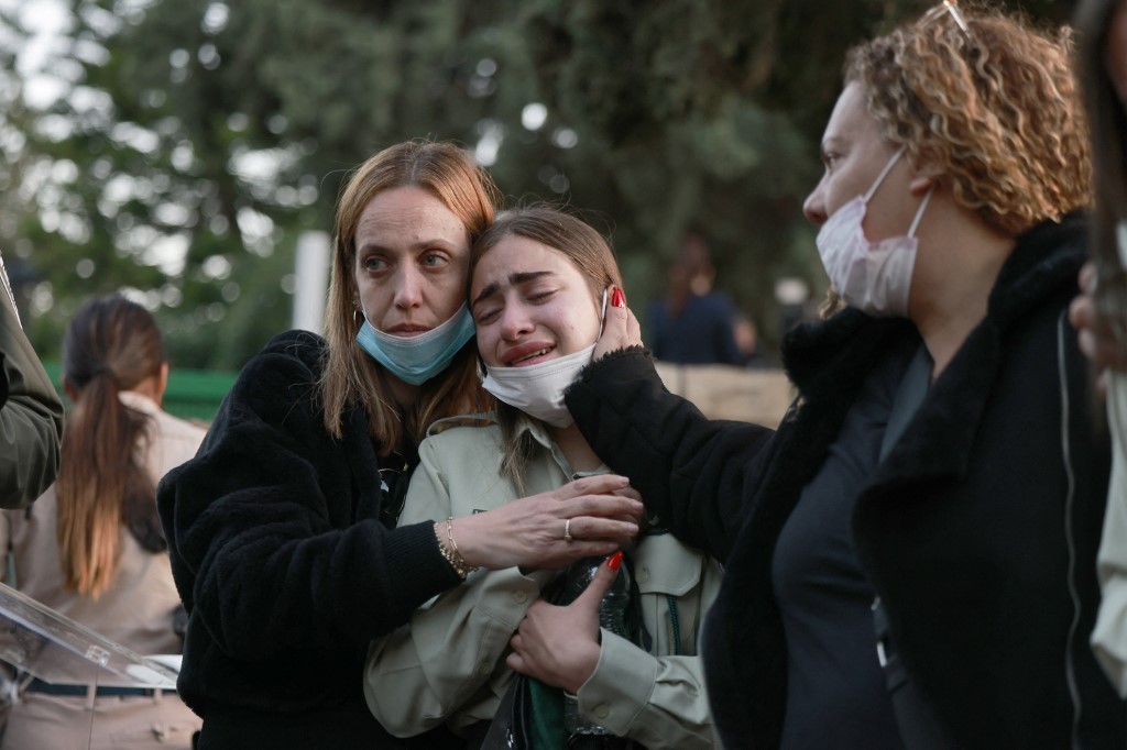 A colleague mourns during the funeral of an Israeli police officer who was killed in a shooting attack on 27 March 2022. (Afp)