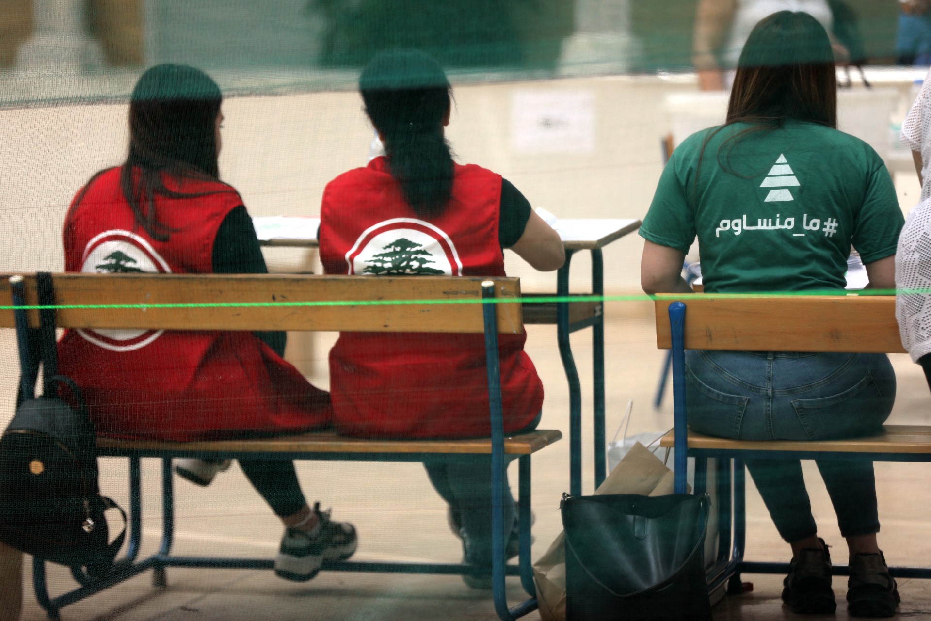 Representatives of candidates from the mainstream Christian parties, Lebanese Forces (L) and Kataeb (R), observe the parliamentary elections at a polling station in Beirut (AFP)