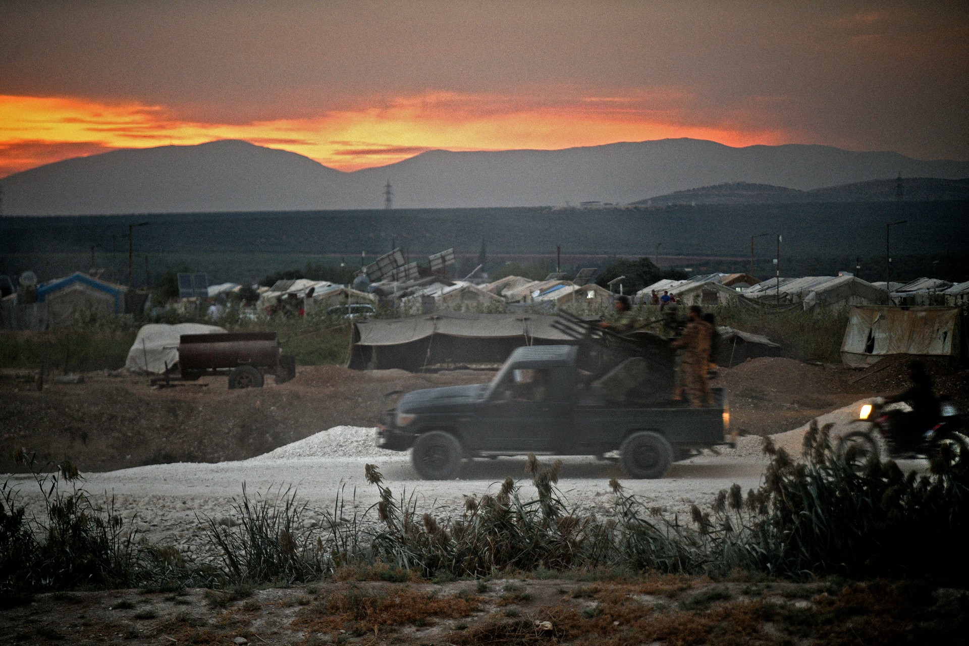 Members of Hay'at Tahrir al-Sham advance towards the village of Jindayris in the Afrin region on 12 October (AFP)