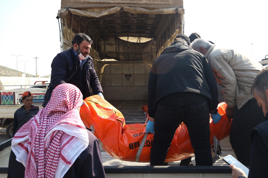 Syrians receive bodies of their loved ones in northern Aleppo after they were repatriated from Turkey (AFP)