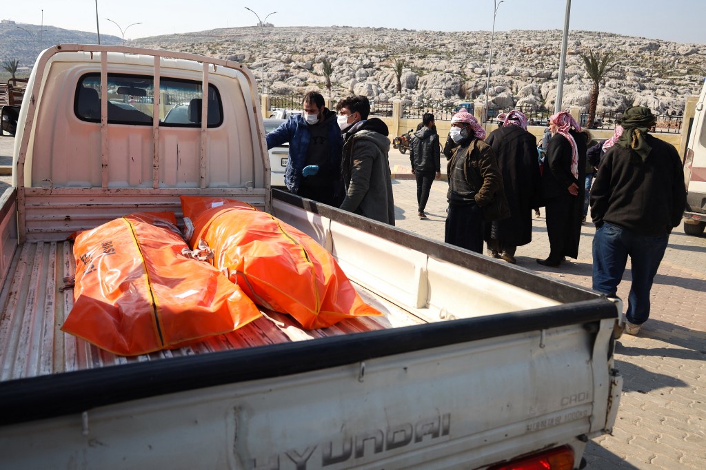 Relatives of Syrians killed in an earthquake in Turkey receive their bodies following their repatriation though the opposition-held crossing of Bab al-Hawa, at the border with Turkey in the northern Aleppo province, on February 12, 2023. Ahmad al-ATRASH / AFP