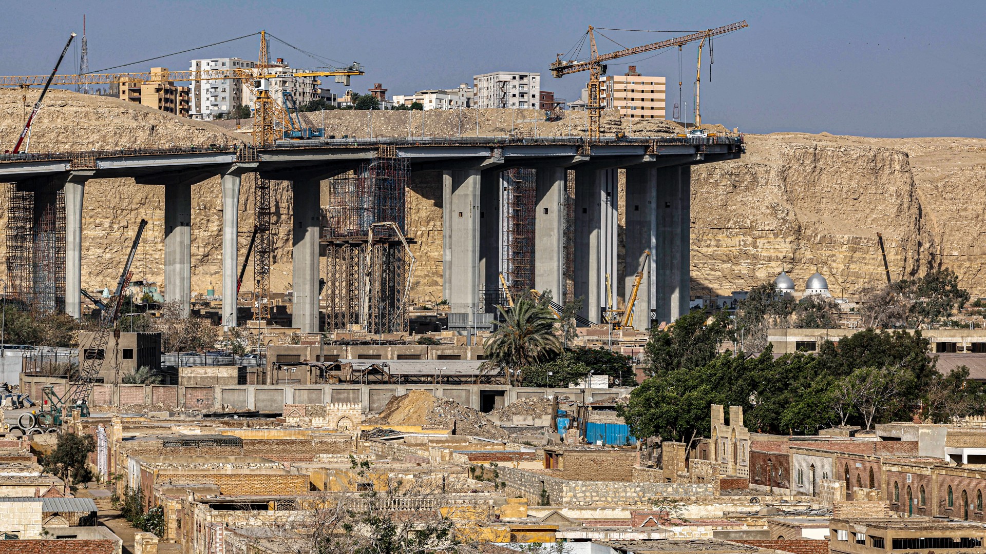 Construction for flyovers in Cairo can be seen rising above the horizon.