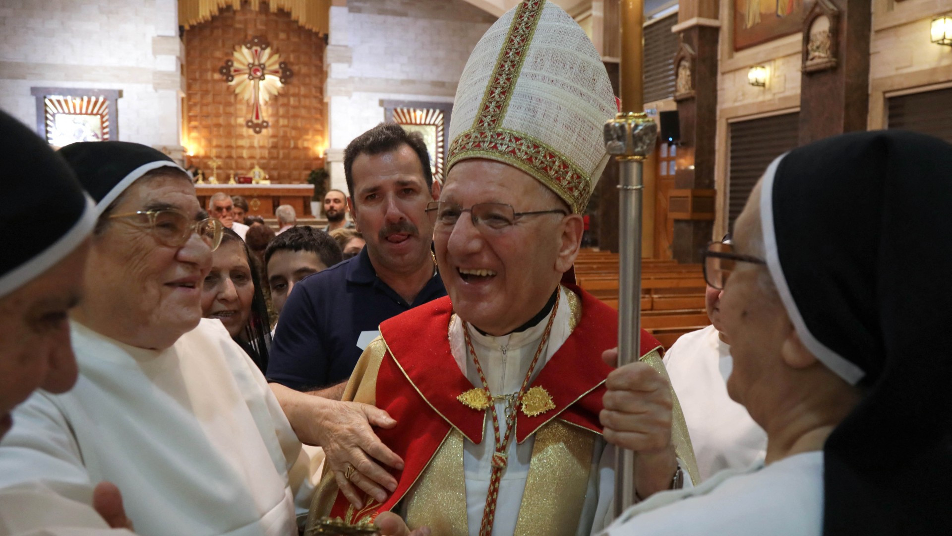 Cardinal Louis Raphael Sako greets nuns following a mass in Erbil on 23 July (AFP)