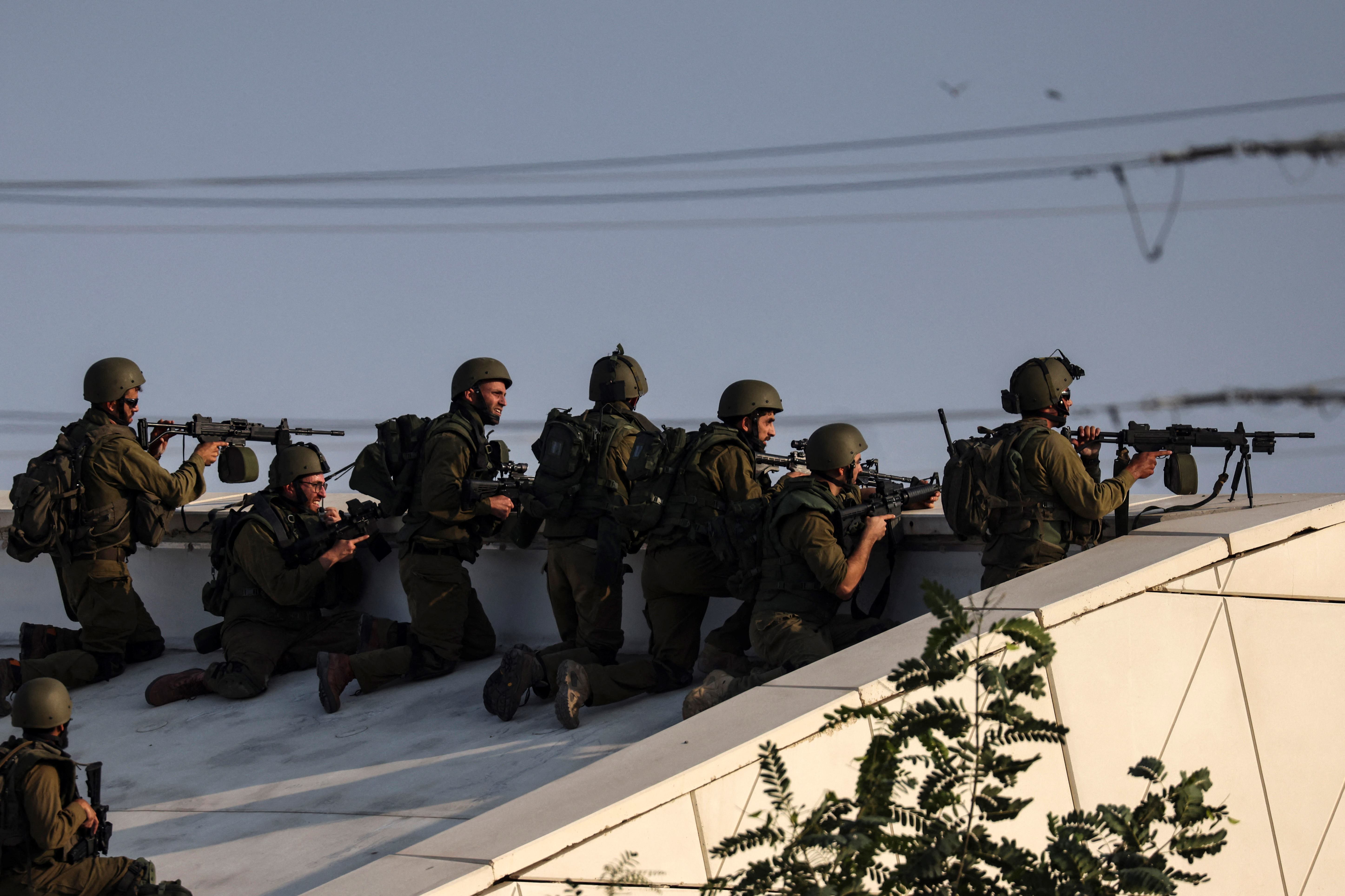 Israeli soldiers take a position near the southern city of Sderot on 8 October (AFP)