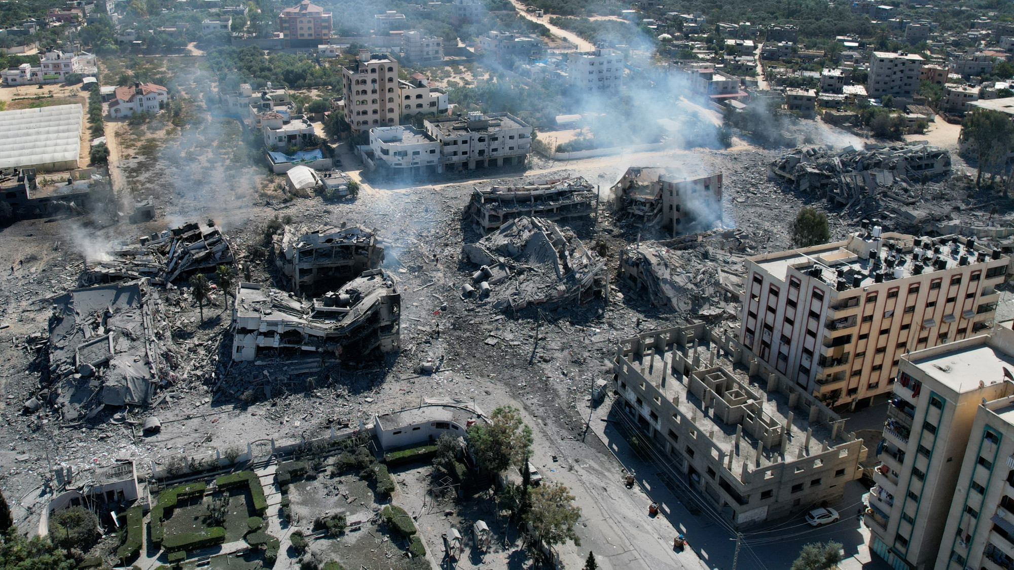 An aerial view shows destroye buildings in al-Zahra city south of Gaza City on 20 October 2023 following Israeli bombardment (AFP)