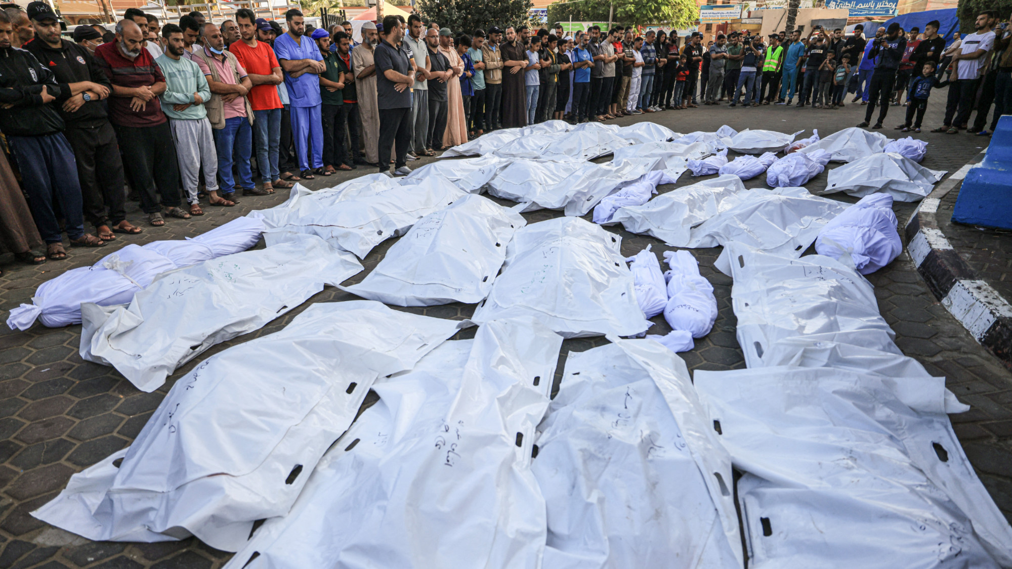 Palestinians gather as they mourn over the bodies of those killed in Israeli bombardment in Deir Balah in the central Gaza Strip, at the Shuhada Al-Aqsa hospital   on 6 November 2023 (AFP)