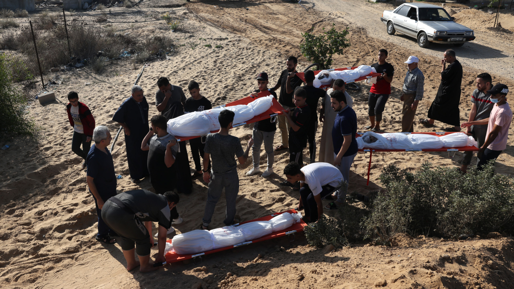 Palestinians take a group of people killed in Israeli bombardment to a burial ground in the Gaza Strip on 6 November 2023 (AFP)
