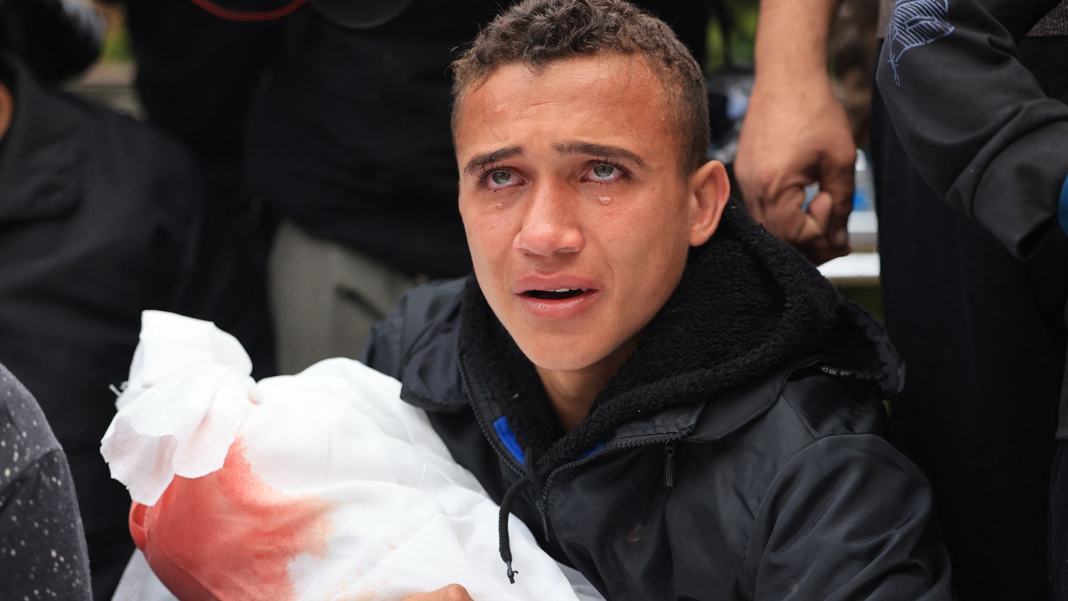 A man mourns during the funeral of his relatives from the Kalusa family, who were killed in an Israeli strike, in Khan Yunis, in the southern Gaza Strip on 22 November 2023.