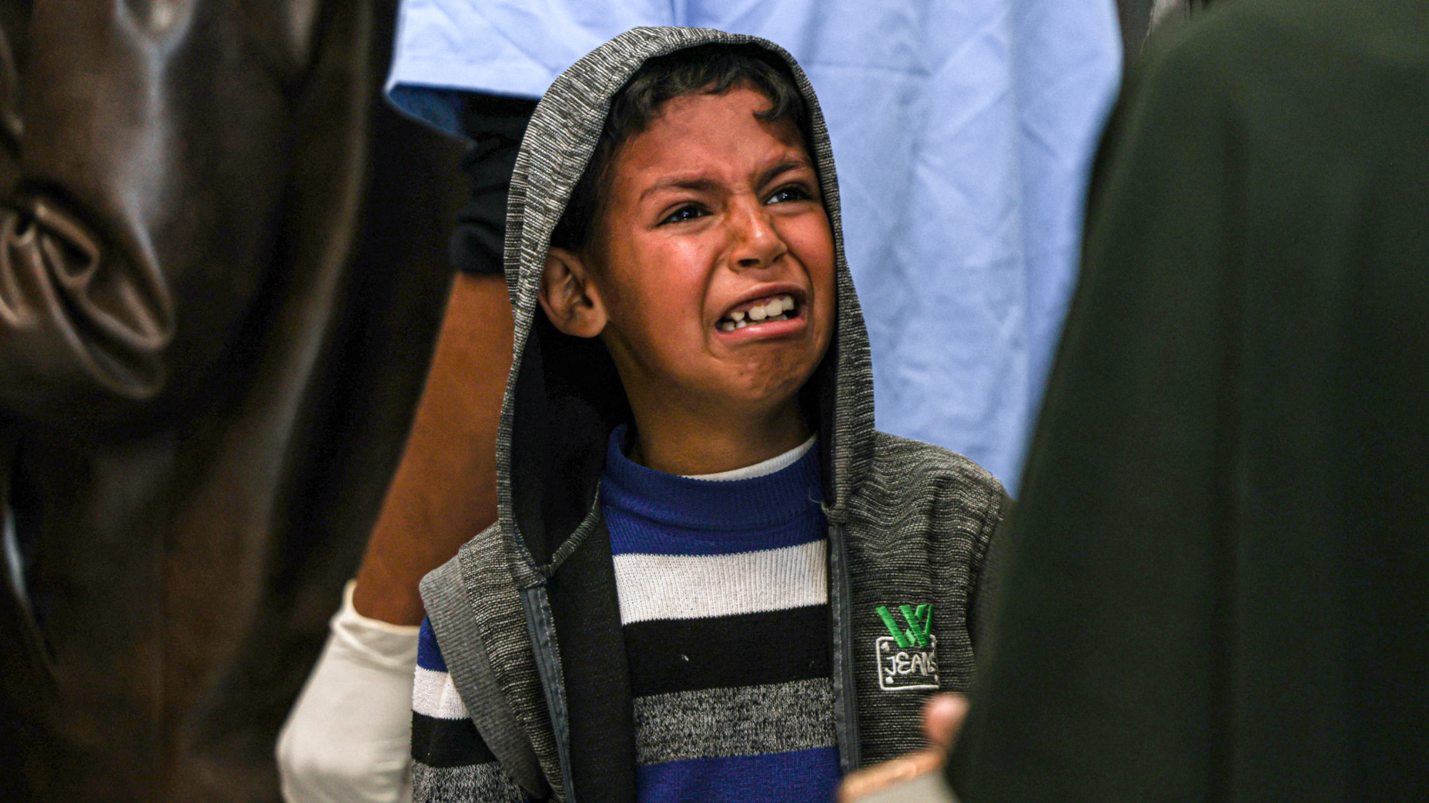 A boy mourn relatives killed in Israeli strikes at the European hospital morgue (Said Khatib/AFP)