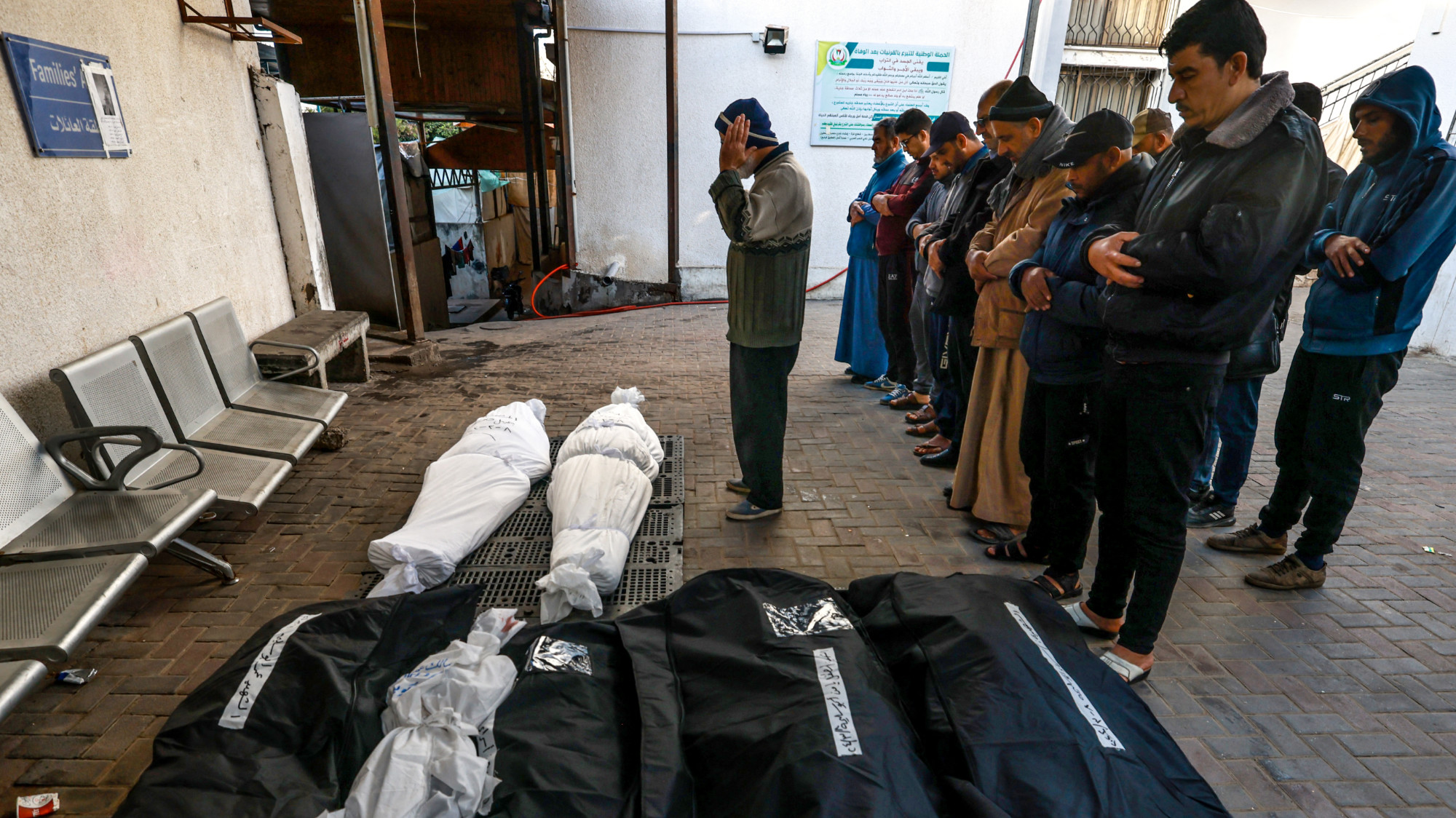 Men pray over the bodies of Palestinians killed in Israeli air strikes on Rafah in the southern Gaza Strip on 8 March 2024 (Mohammed Abde/AFP)