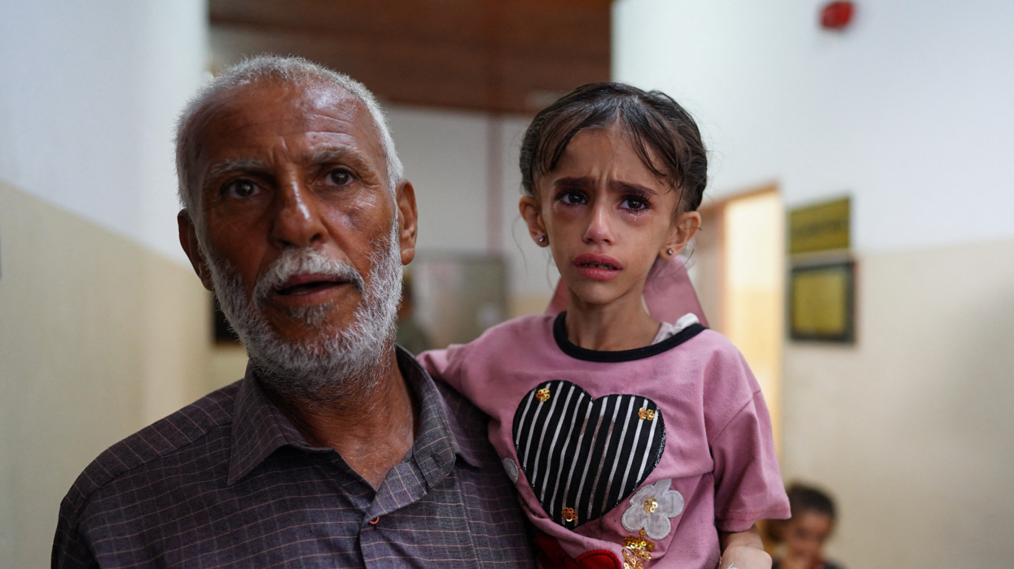 Palestinian man carries a child suffering of malnutrition at Nasser hospital in Khan Yunis on 24 June 2024 (AFP/Basher Taleb)