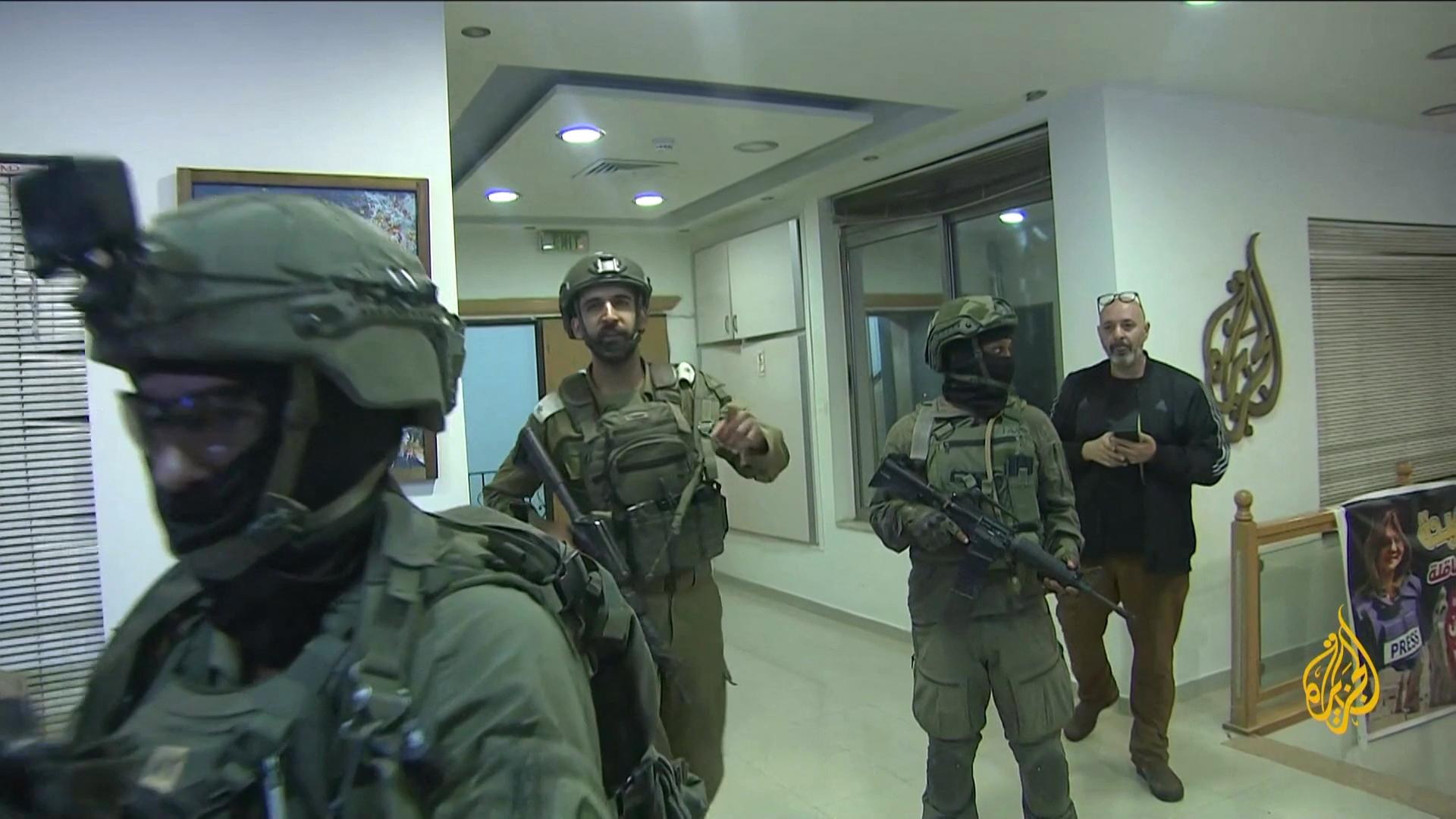 An image grab from footage distributed by the Doha-based Al-Jazeera TV on September 22, 2024 shows Israeli soldiers entering Al Jazeera's office in Ramallah, in the West Bank to issue a 45-day closure order on September 21