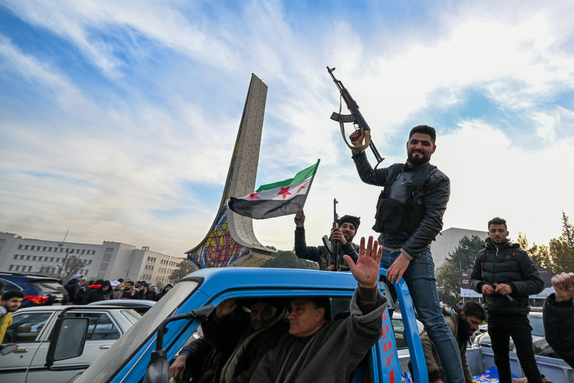 People celebrate in Damascus on 8 December (AFP)
