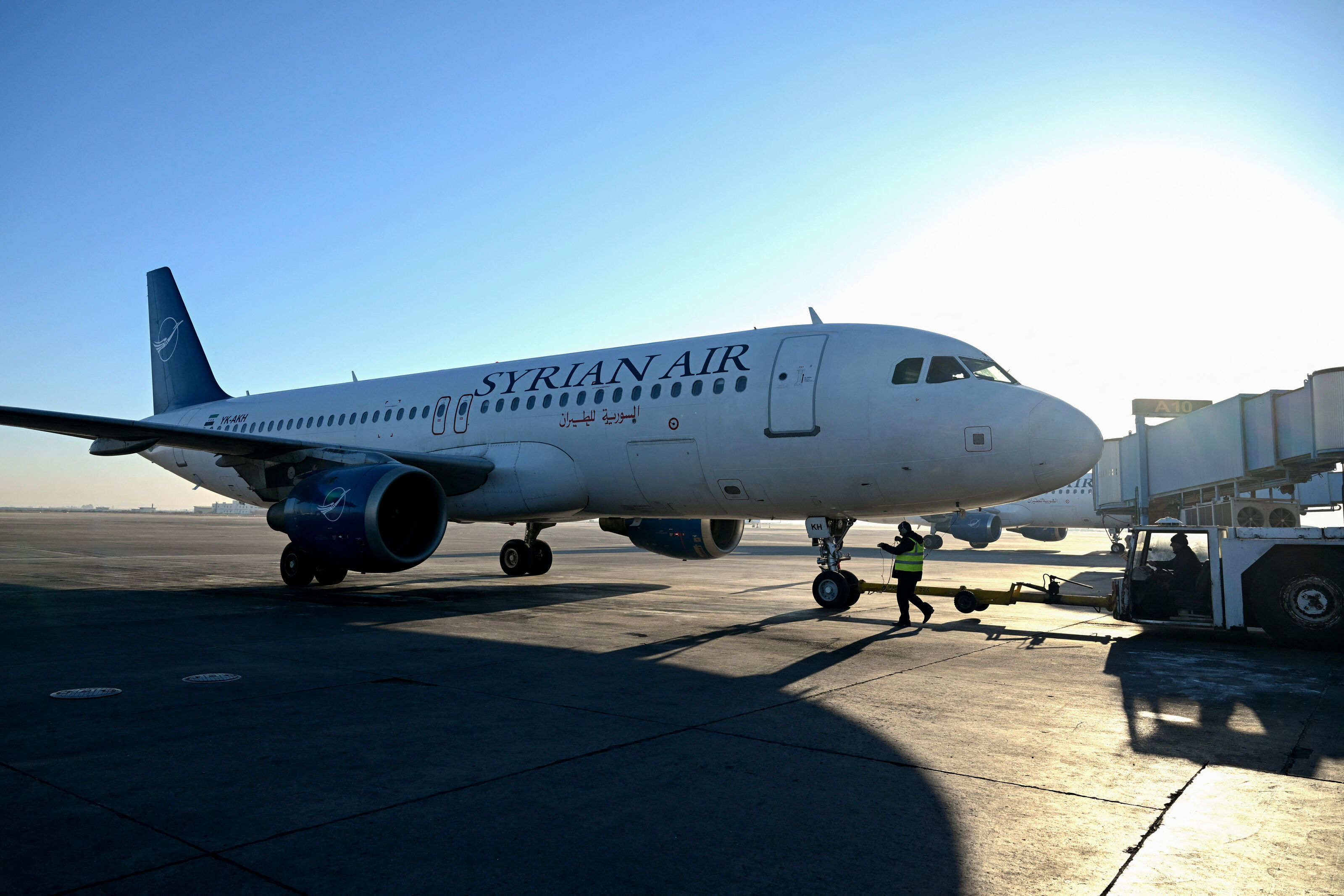 Ground personnel prepare a Syrian Air aircraft before a flight to the city of Aleppo on December 18, 2024, at Damascus international airport. The first flight since the ouster of Syria's president Bashar al-Assad took off on December 18, from Damascus airport to Aleppo in the country's north. (AFP)