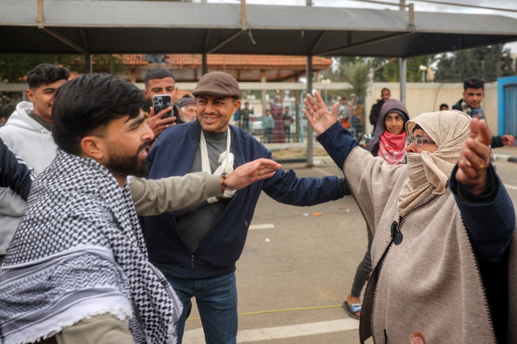 One of the Palestinian prisoners released rushes to embrace his mother upon arrival at the European Hospital in Khan Yunis in the southern Gaza Strip on February 8, 2025. (Eyad Baba/AFP)