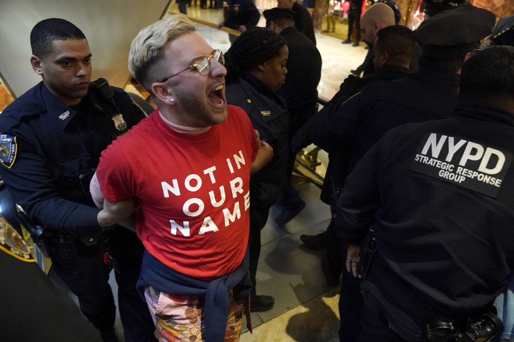 Demonstrators from the rights organization Jewish Voice for Peace are detained by NYPD officers as they hold a civil disobedience action inside Trump Tower in New York on March 13, 2025. (TIMOTHY A. CLARY/AFP)