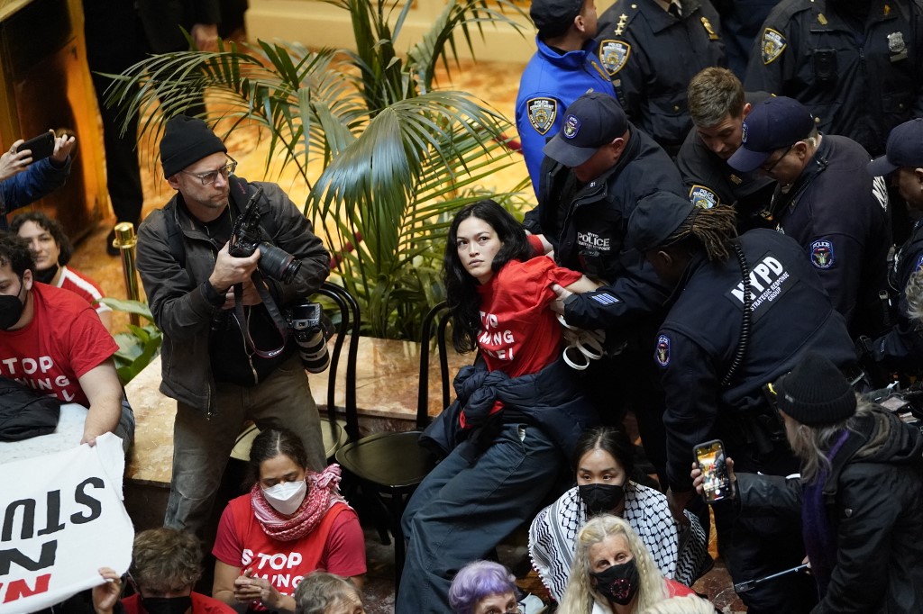 Demonstrators from the rights organization Jewish Voice for Peace are detained by NYPD officers as they protest inside Trump Tower in New York on March 13, 2025. (TIMOTHY A. CLARY/AFP)