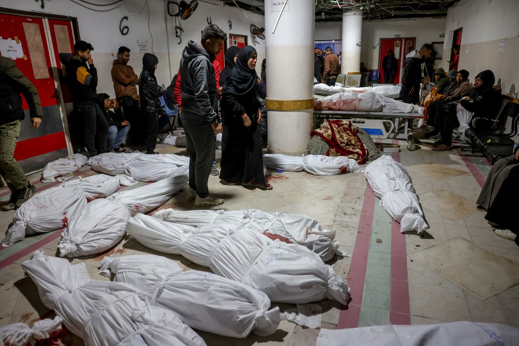 Palestinians react near the bodies of the victims of Israeli overnight air strikes in the northern Gaza Strip, at the Indonesian Hospital in Beit Lahia, on March 20, 2025. (AFP)