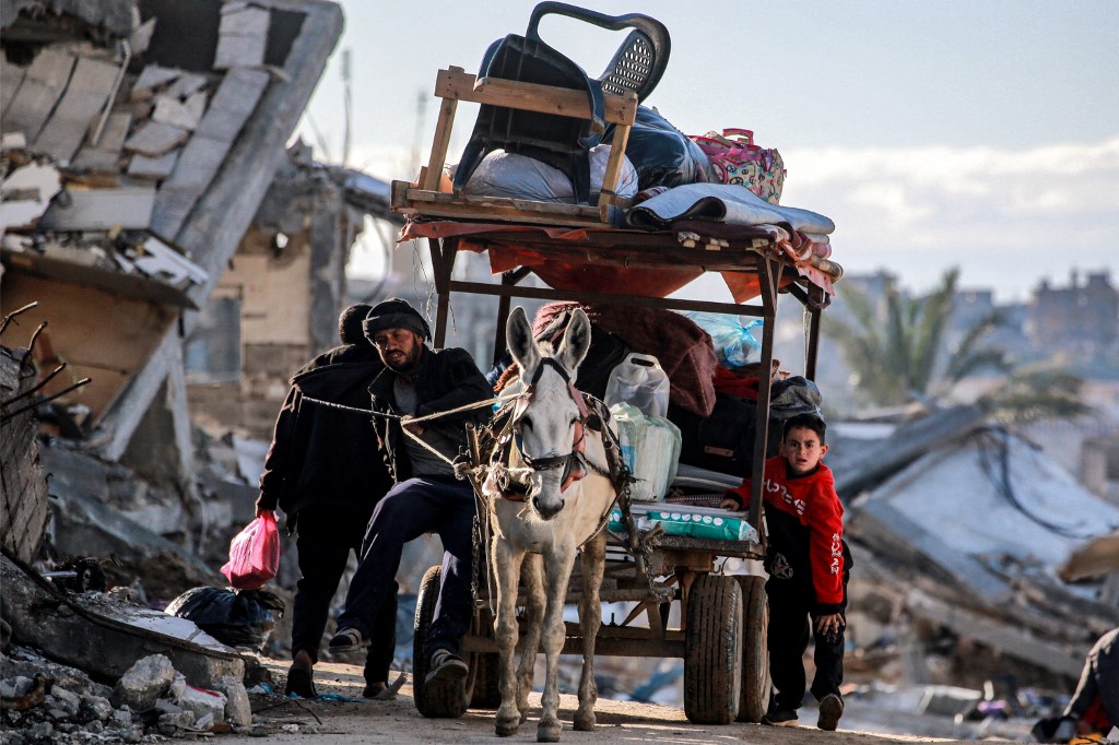 A donkey pulls a cart loaded with people's belongings as those displaced by conflict from Beit Lahia arrive in Gaza City on March 22, 2025. (AFP)