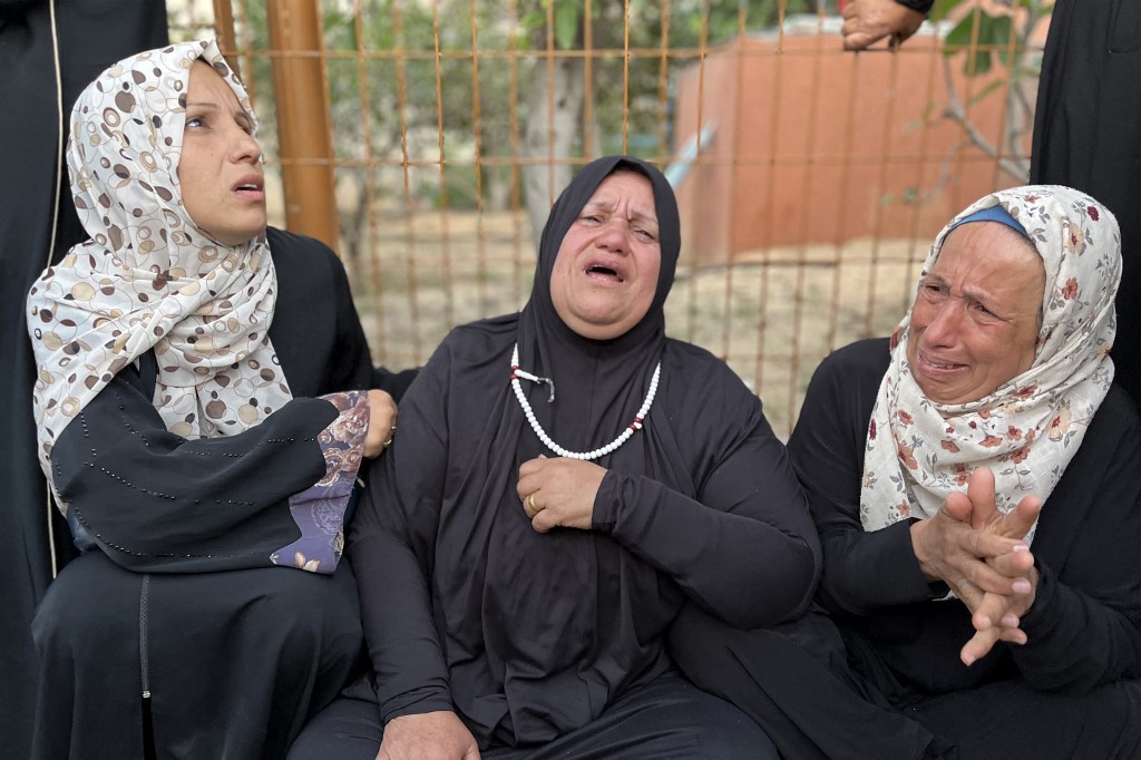 Women gather in mourning outside Nasser Medical Complex in Khan Yunis in the southern Gaza Strip on March 30, 2025 as the bodies of Palestinian first responders who were killed a week before in Israeli military fire on ambulances arrive at the facility. (AFP)