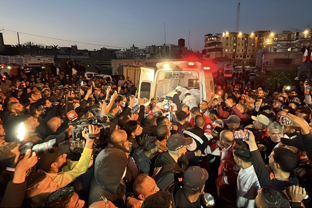 Paramedics transport out of an ambulance some of the bodies of Palestinian first responders, who were killed in Israeli military fire on ambulances in the southern Gaza Strip on March 30, 2025. (AFP)