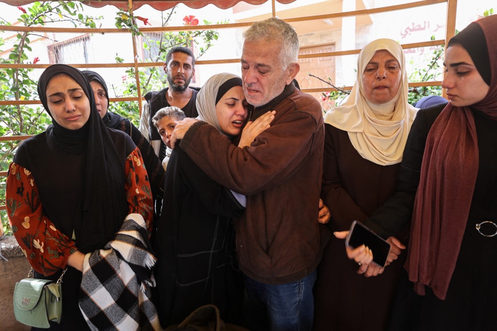 Palestinians mourn the death of loved ones killed in Israeli strikes, before a funeral procession at Nasser hospital in Khan Younis in the southern Gaza Strip, on 2 April, 2025. (AFP)