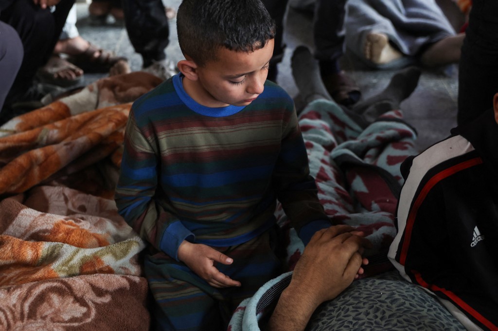 A boy mourns over the body of a loved one killed in overnight Israeli bombardment on northern Gaza, at the Ahli Arab Hospital, also known as the Maamadani (Baptist) Hospital, in Gaza City on 3 April, 2025. (AFP)