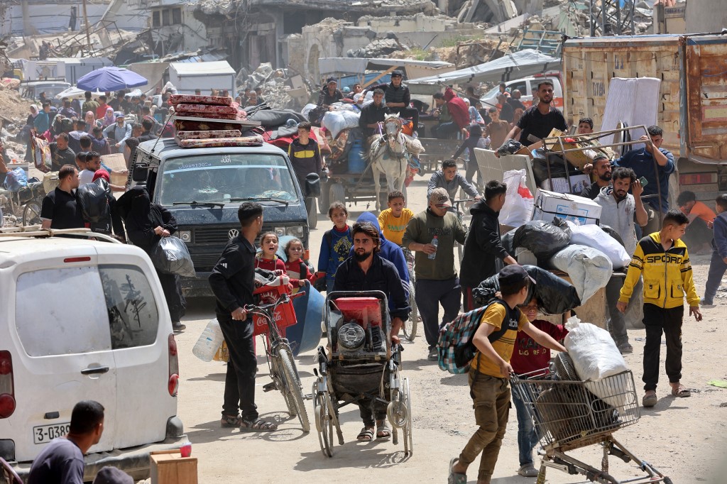 Palestinians transport their belongings as they flee Gaza City's eastern neighbourhood of Shujaiya following an evacuation order issued by the Israeli military on April 3, 2025. 