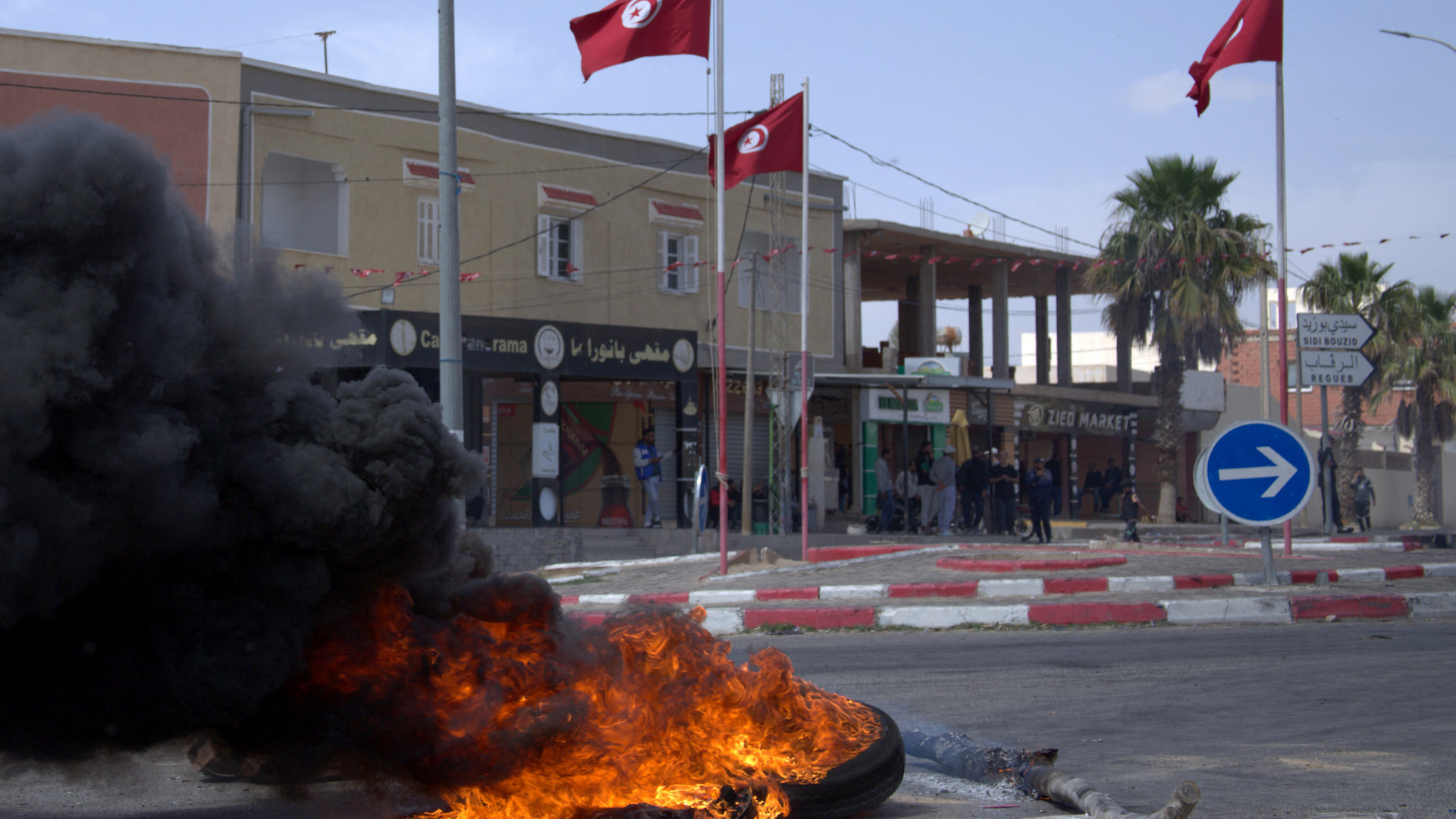 Tunisians burn tyres and block a road in Mazouna, Sidi Bouzid, on 15 April 2025, during a protest demanding justice after a school wall collapse killed three students (Saber Sboui/AFP)