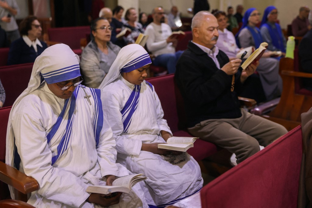 Nuns and Palestinian worshippers attend mass held for late Pope Francis at the Holy Family Church in Gaza on April 21, 2025.