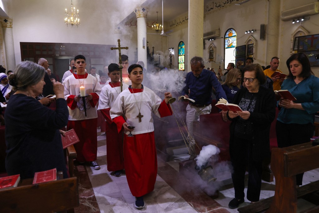 Palestinians attend mass held for late Pope Francis at the Holy Family Church in Gaza on April 21, 2025. 