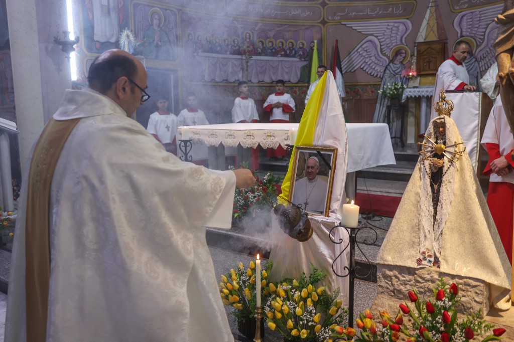 Members of the clergy hold mass for late Pope Francis at the Holy Family Church in Gaza City on April 21, 2025. 