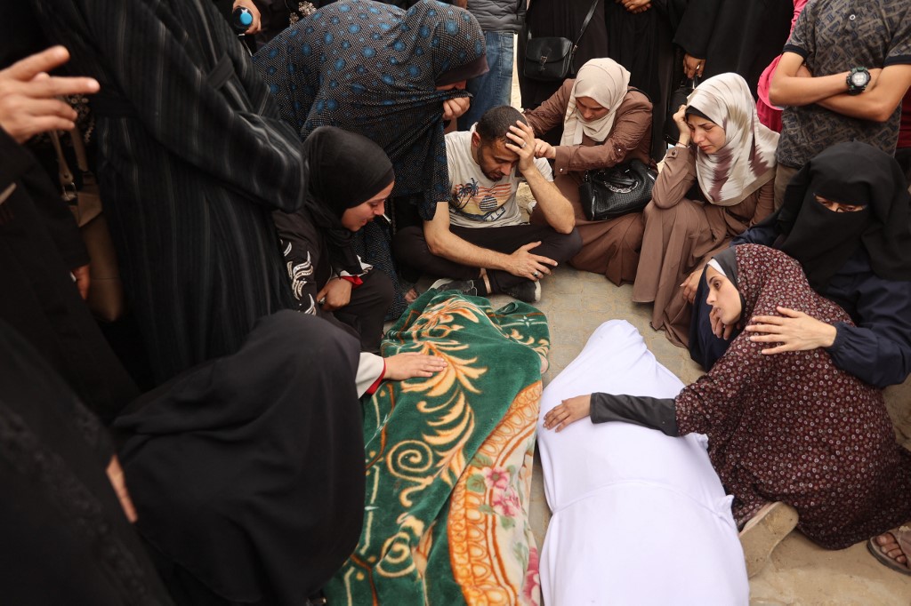 Palestinians mourn during a funeral of relatives, killed in an Israeli strike on a school-turned-shelter, at the Al-Shifa hospital in Gaza City on April 23, 2025. 
