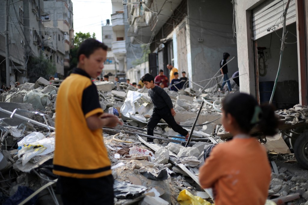 A Palestinian boy walks amid the rubble of a building destroyed in an Israeli strike at the Bureij refugee camp in the central Gaza Strip on April 27, 2025. 