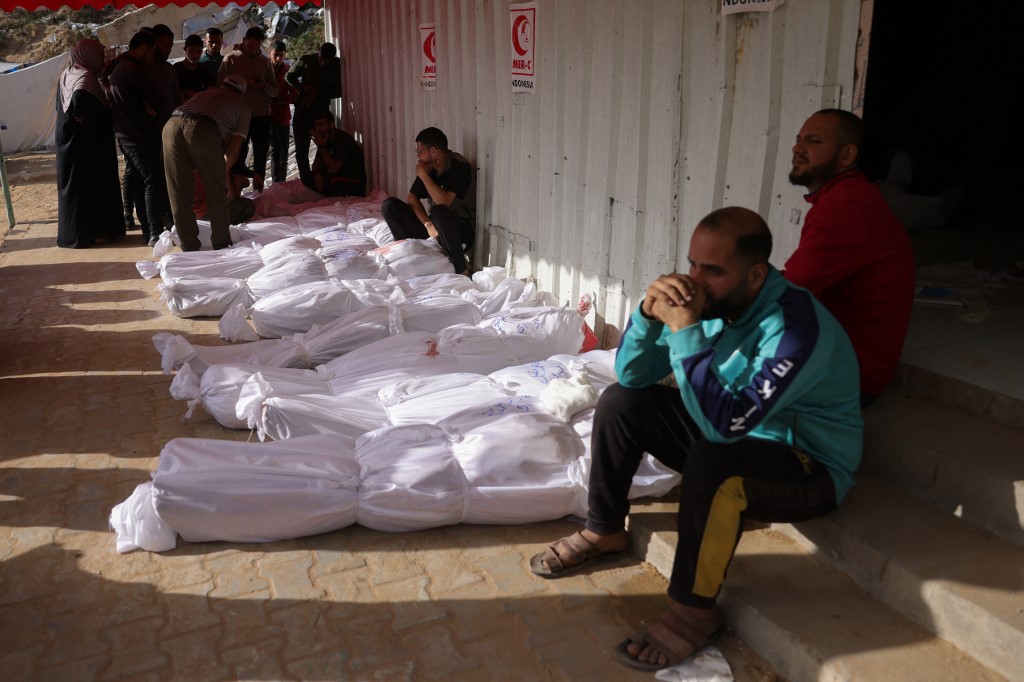 People mourn near the bodies of victims of Israeli strikes on Jabalia, at the Indonesian Hospital in Beit Lahia in the northern Gaza Strip on May 14, 2025.
