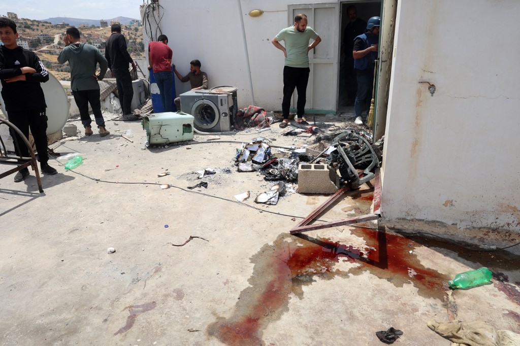 Blood stains cover the floor as people check the damage in a house after Israeli troops surrounded it and reportedly killed five people who were inside, during an army raid on Tammun in the occupied West Bank on May 15, 2025.