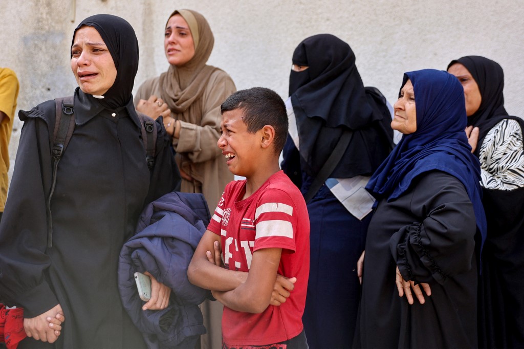 Women mourn relatives killed in an Israeli strike, at Al-Shifa hospital in Gaza City on May 26, 2025. Rescuers said at least 20 people were killed, mostly children, and more than 60 wounded in an Israeli strike on a school sheltering displaced people in Gaza City on May 26.