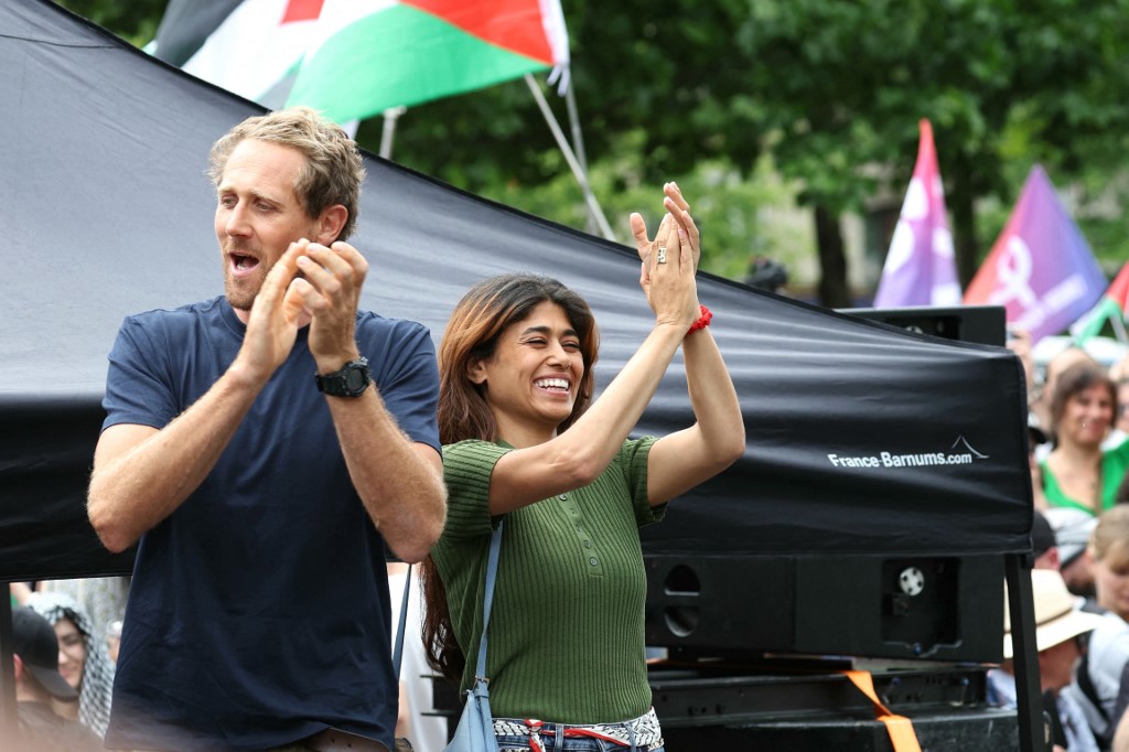 French-Palestinian lawyer and member of European Parliament for La France Insoumise (LFI) party Rima Hassan and member of the Gaza-bound aid boat Reva Viard (L) take part in a pro-Palestinian demonstration called by several French unions at the Place de la République in Paris on June 14, 2025.