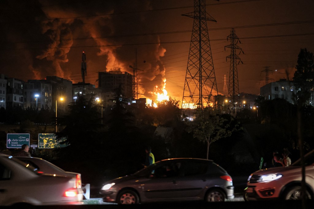 A fire blazes in the oil depots of Shahran, northwest of Tehran, on June 15, 2025. Israel and Iran exchanged fire on June 14, a day after Israel unleashed an unprecedented aerial bombing campaign that Iran said hit its nuclear facilities, 